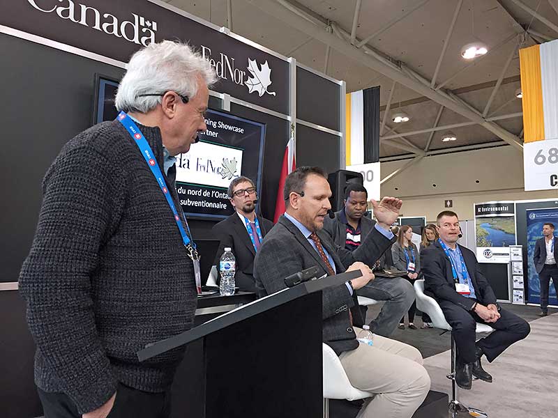 Close up of host Bob McDonald and panelists